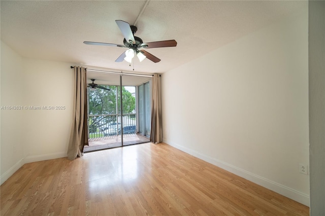 empty room featuring light wood-type flooring and baseboards