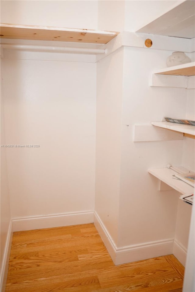 walk in closet featuring light wood-style floors