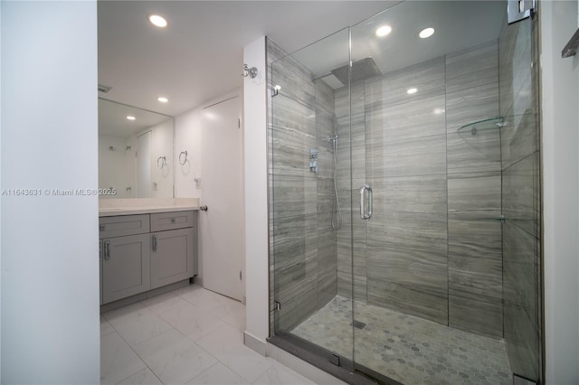 full bath with marble finish floor, a shower stall, vanity, and recessed lighting