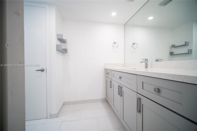 bathroom with recessed lighting, vanity, and baseboards