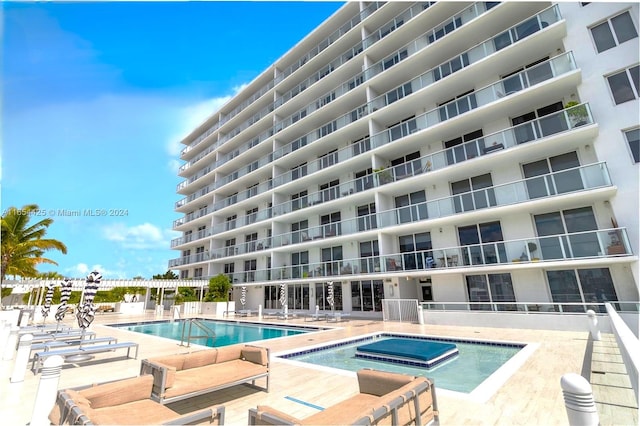 view of swimming pool featuring a community hot tub