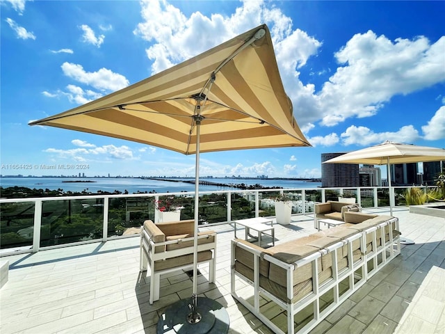 deck featuring outdoor lounge area and a water view