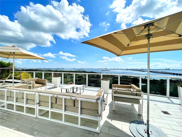 view of patio featuring a water view and outdoor lounge area