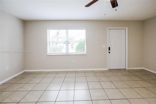 tiled empty room featuring ceiling fan