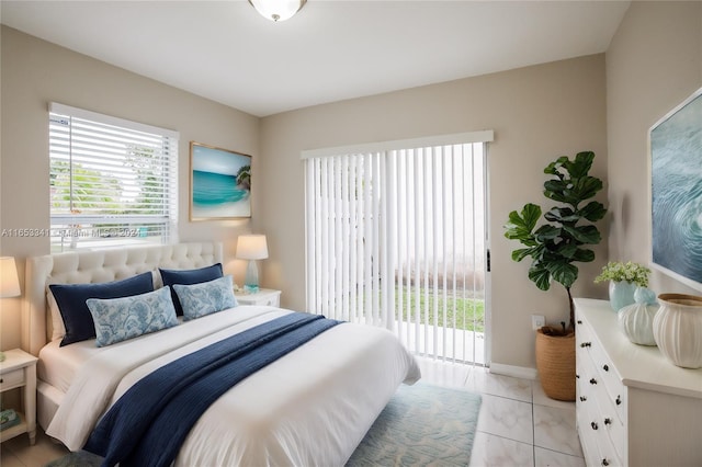 bedroom featuring light tile patterned floors and access to outside