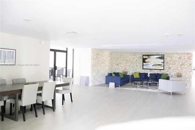 dining space featuring floor to ceiling windows and hardwood / wood-style flooring