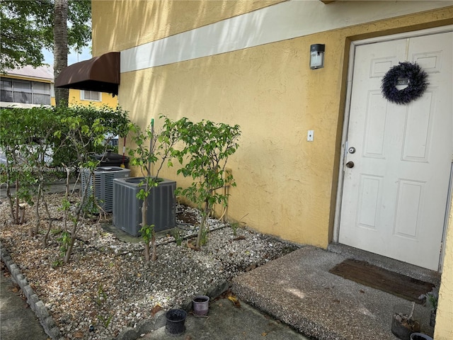 doorway to property with central AC unit