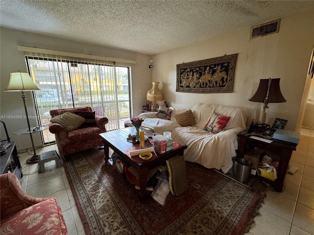 living room with a textured ceiling and tile patterned floors