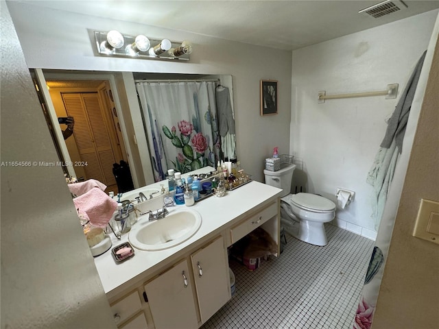 bathroom with tile patterned floors, a shower with curtain, toilet, and vanity