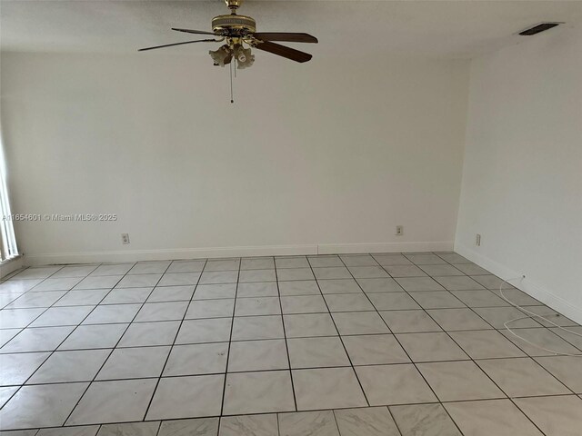 empty room featuring ceiling fan and light tile patterned floors