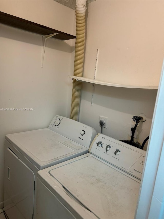 clothes washing area with washer and clothes dryer