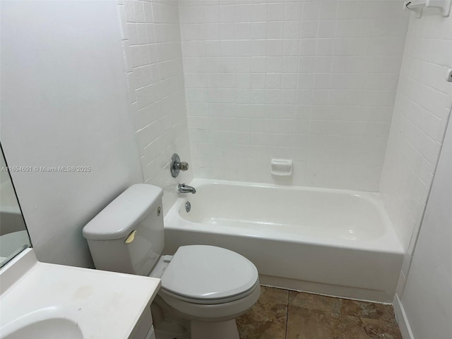 full bathroom with vanity, tiled shower / bath combo, and toilet