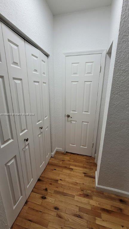 hallway featuring wood-type flooring