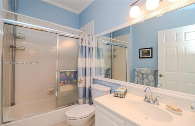 full bathroom featuring ornamental molding, vanity, shower / tub combo, and toilet