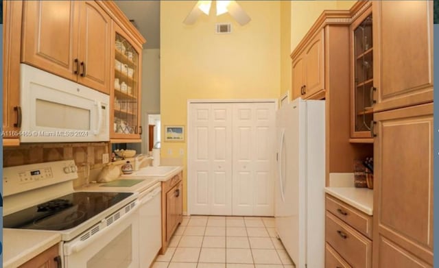 kitchen with ceiling fan, sink, light tile patterned floors, and white appliances