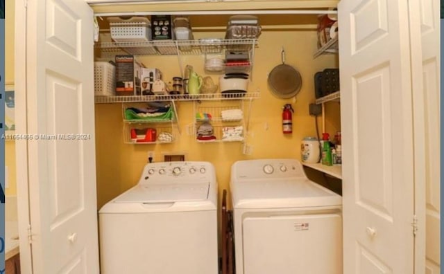 clothes washing area featuring separate washer and dryer