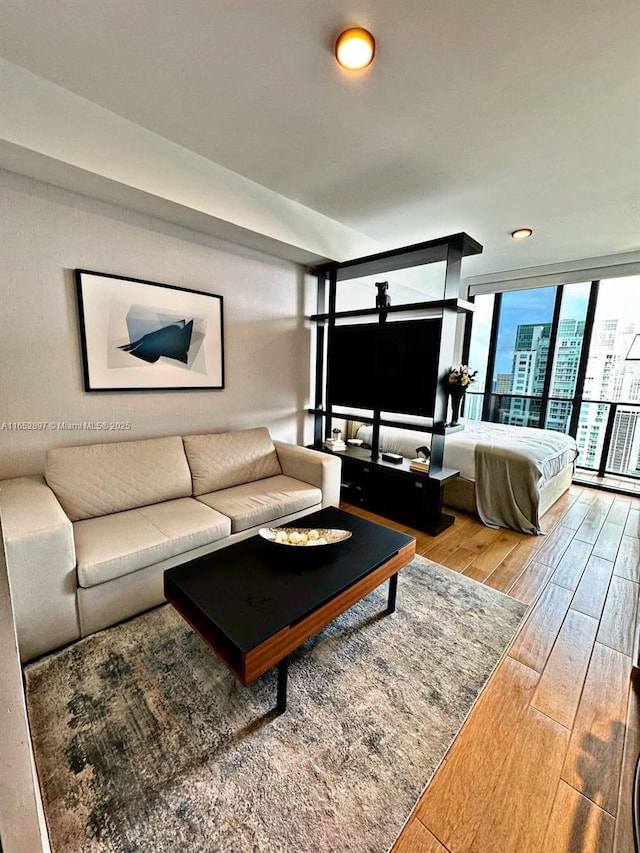 living room with hardwood / wood-style floors and a wall of windows