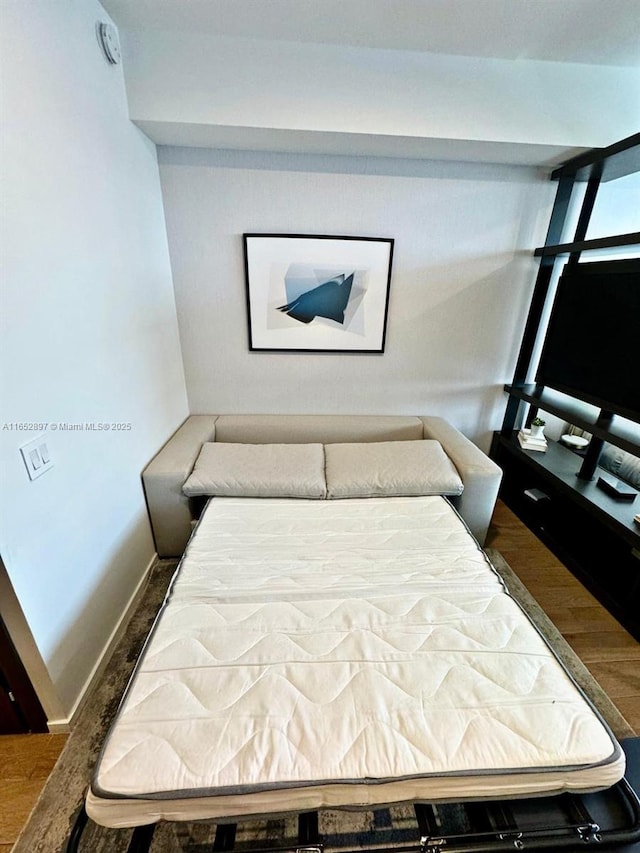 bedroom with wood-type flooring