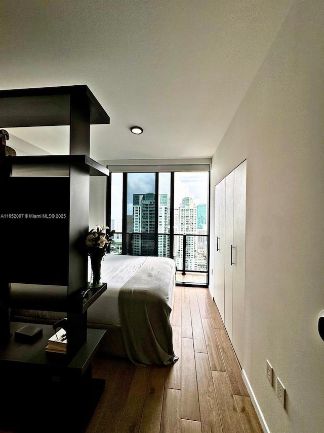 bedroom featuring hardwood / wood-style flooring and floor to ceiling windows