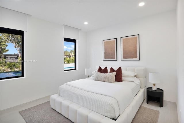 bedroom featuring light wood-type flooring and multiple windows