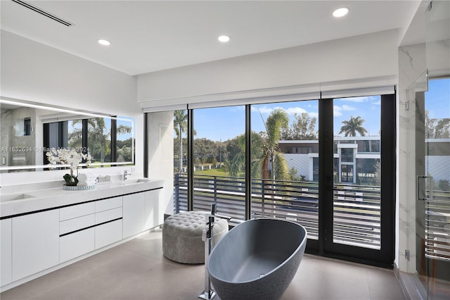 bathroom featuring vanity and a bath