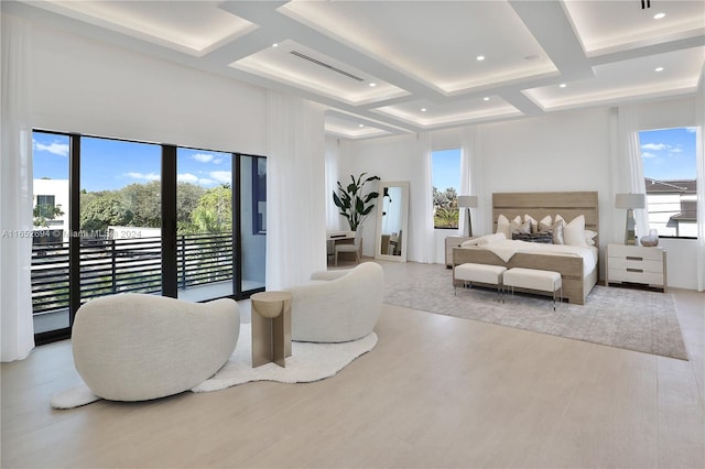 bedroom featuring beam ceiling, light wood-type flooring, multiple windows, and coffered ceiling