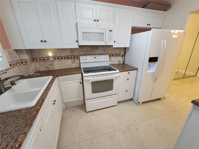 kitchen with a sink, tasteful backsplash, white appliances, and white cabinets