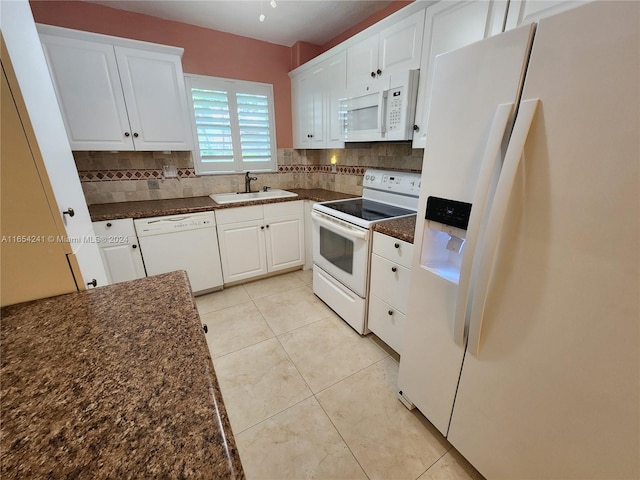 kitchen with a sink, decorative backsplash, white appliances, and white cabinets