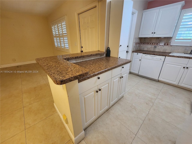 kitchen featuring dishwasher, white cabinetry, a sink, and decorative backsplash