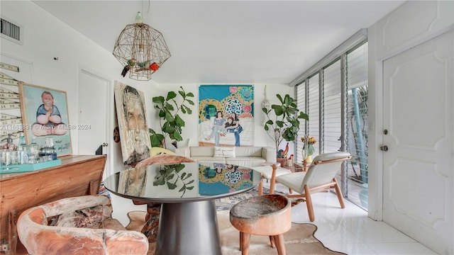 tiled dining space with a notable chandelier