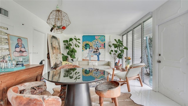 tiled dining area featuring visible vents