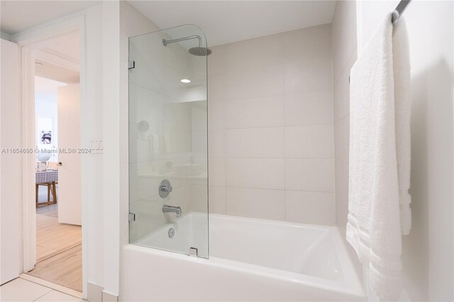 bathroom featuring combined bath / shower with glass door and hardwood / wood-style flooring