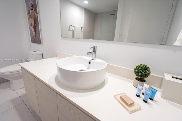 bathroom featuring tile patterned floors, a shower, toilet, and vanity