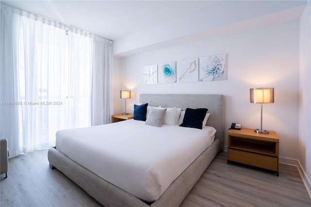 bedroom featuring light wood-type flooring and multiple windows