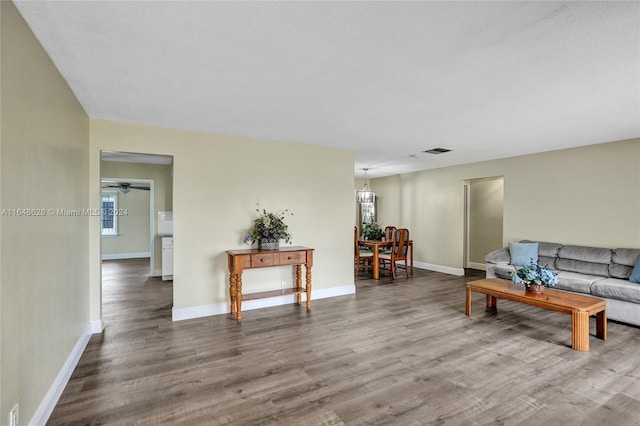 living room with a textured ceiling, dark wood-type flooring, ceiling fan, and a healthy amount of sunlight