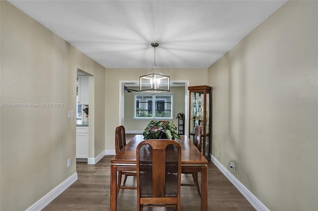 dining space featuring dark hardwood / wood-style floors and a notable chandelier