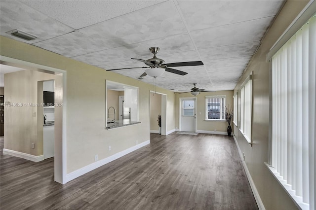 empty room featuring ceiling fan, dark hardwood / wood-style flooring, and sink