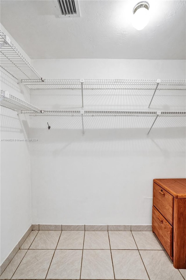 spacious closet with light tile patterned floors