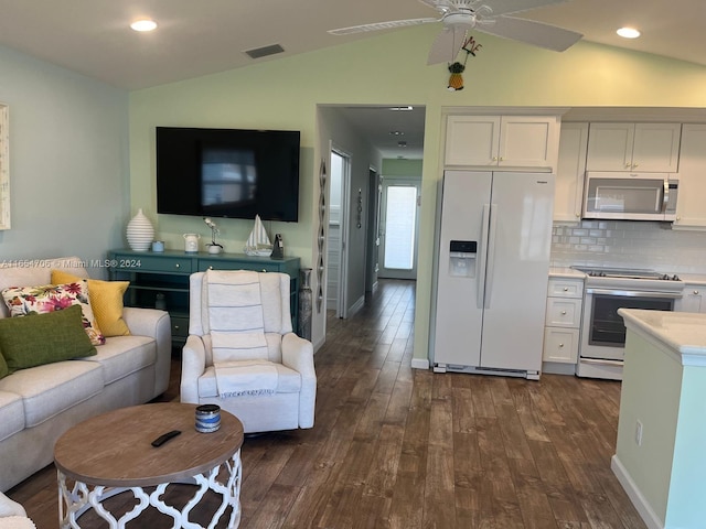 living room featuring dark wood-type flooring, lofted ceiling, and ceiling fan