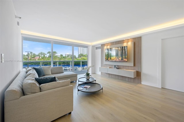 20505 E Country Club Dr Unit 231, Aventura, FL 33180 - living room with a wall of windows, a wealth of natural light, and light wood finished floors