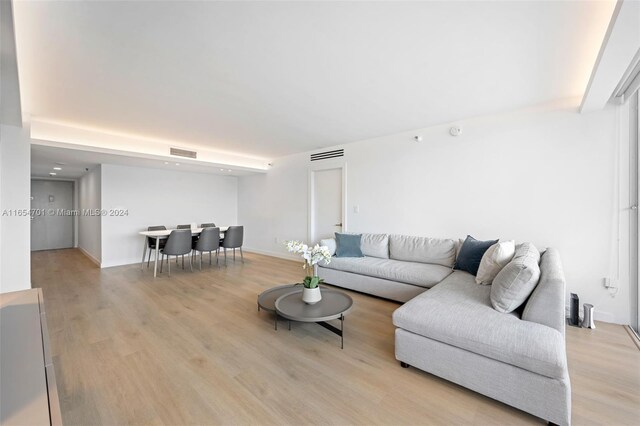 20505 E Country Club Dr Unit 231, Aventura, FL 33180 - living room featuring visible vents, baseboards, and light wood-style floors