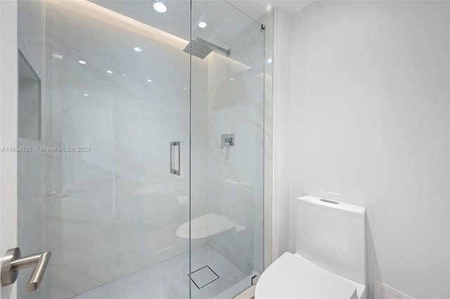 bathroom featuring toilet and an enclosed shower