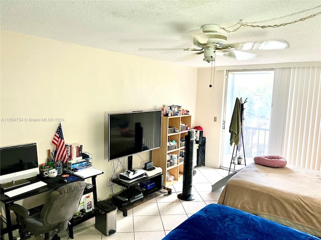 bedroom featuring ceiling fan, light tile patterned floors, and a textured ceiling