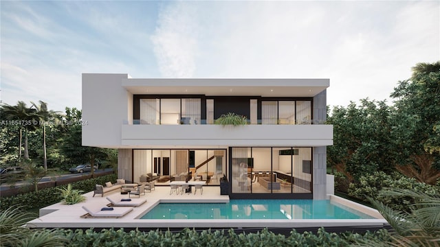 rear view of house featuring a balcony and a patio