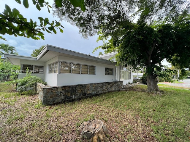 view of side of home featuring a yard