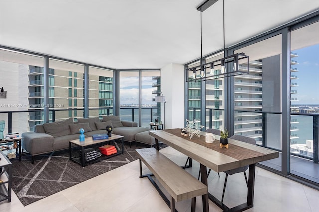 dining space with expansive windows and a water view