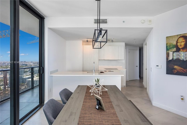 dining space featuring expansive windows and sink