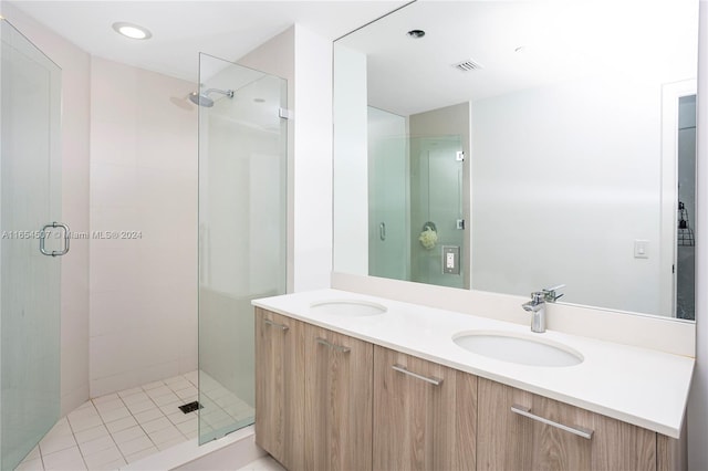 bathroom featuring an enclosed shower and vanity