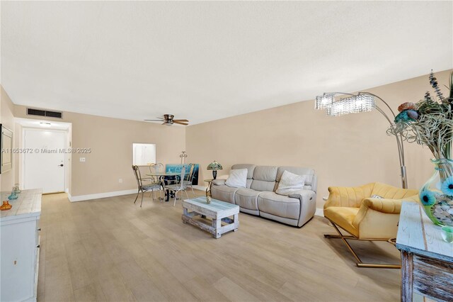 living room with light wood-type flooring and ceiling fan