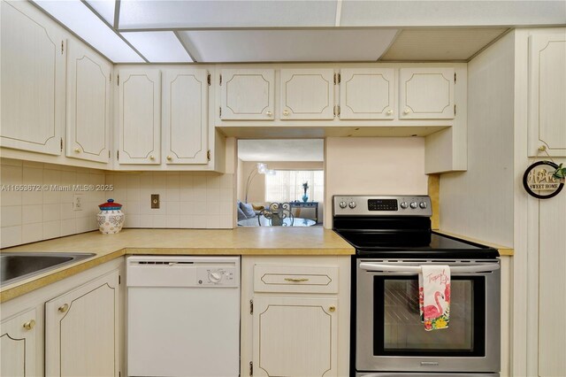 kitchen featuring white dishwasher, stainless steel electric range oven, and backsplash